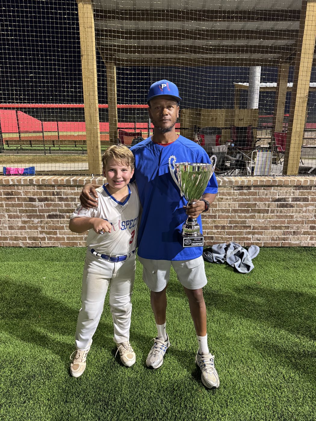 Coach C with Prospect player and championship trophy