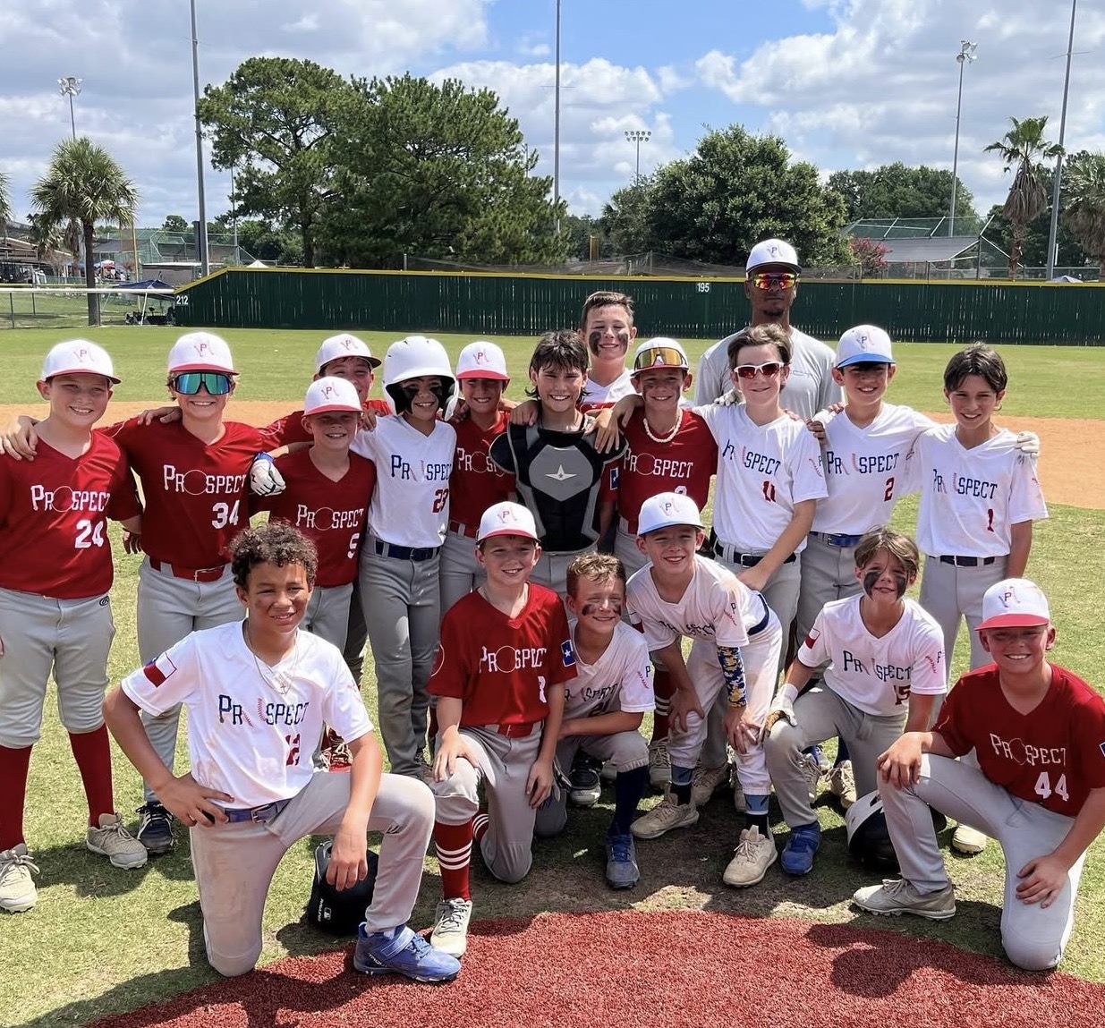 Prospect Baseball team in red and white on the field